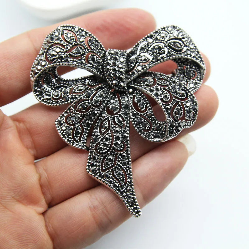 https://ae-pic-a1.aliexpress-media.com/kf/S78c7bf48279b4639bd6b68d79916ffb3i/Luxury-Crystal-Bow-Ribbon-Brooches-For-Women-Men-Fashion-Bowknot-Pins-Jewelry.jpg